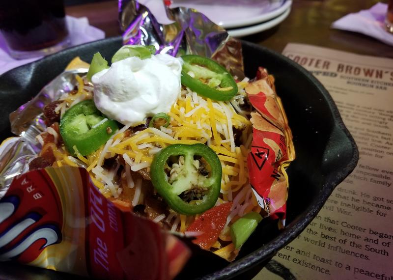 I like to decorate my Cooter Brown's Texas Frito Pie with a sprinkle of festive green jalapenos. The resulting endorphins can be moderated by ordering a Burnt Orange Manhattan. BOB YESBEK PHOTO